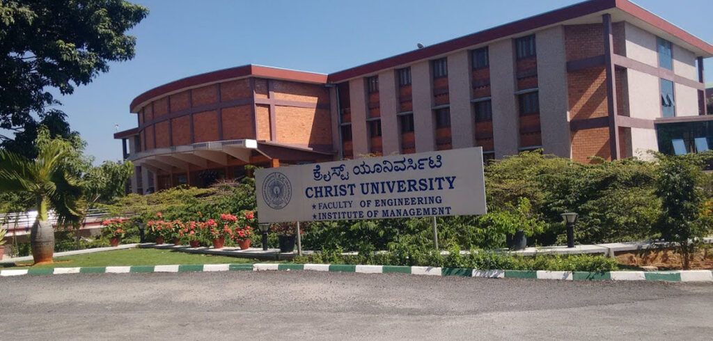 A serene view of Christ College Bangalore's campus highlighting its modern architecture and green spaces